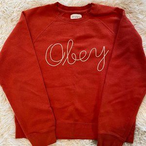 orange Obey brand sweatshirt